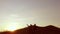 People group of tourists walking on top of a sunset silhouette travel mountain. Slow video tourists people group go