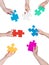 People hands circle with different puzzle pieces