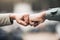 People, hands and fist bump for agreement, deal or trust in partnership, unity or support on a blurred background. Hand
