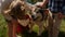 People hands petting pet closeup. Fluffy husky enjoy family walk on green meadow