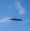 People are hanging in the air at a great height on an extreme rocket carousel in an amusement park