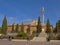 People hanging out on Plaza del Trion square with Satue of Mary Immaculate and the Royal Hospital of Granada, Spain