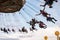 People have fun at the carousel flying swing ride attraction at Tibidabo Amusement Park