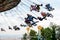 People have fun at the carousel flying swing ride attraction at Tibidabo Amusement Park