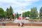 People have a rest in city park with fountains. Urban panorama. Eastern Europe