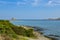 People having bath in Mediterranean Sea in Stintino, Italy with beautiful views on historic tower