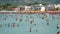 People having fun and bath at the sea of the beach of the italian village