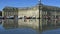 People having fun in a mirror fountain in front of Place de la Bourse in Bordeaux, France