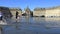 People having fun in a mirror fountain in front of Place de la Bourse in Bordeaux, France