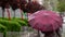 People hide from rain under umbrellas in a rainy day on the street of the city Bad weather concept