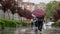 People hide from rain under umbrellas in a rainy day on the street of the city Bad weather concept