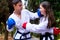 People high kicks during training of taekwondo outdoors bamboo background