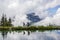 People hiking along a mountain lake Haerzlisee with reflecion on the water