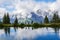 People hiking along a mountain lake Haerzlisee with reflecion on the water surface