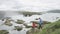 People hiking in nature hike by Iceland waterfall