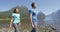 People hiking in New Zealand in Milford Sound by Mitre Peak in Fiordland