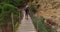 People hiking in Royal Trail El Caminito del Rey in gorge Chorro