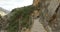 People hiking in Royal Trail El Caminito del Rey in gorge Chorro