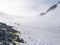 People hiking on snow slope of Spigot Peak in mist, Graham Land