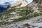 People hiking towards alpine hut Dreizinnenhutte in Sexten Dolomites, South Tyrol