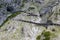 People at hiking trail through Austrian mountains to ice cave