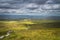 People hiking on wooden boardwalk winding between hills and fields, Cuilcagh Mountain Park