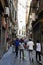 People on Historic Narrow Pedestrian Street Via San Luca, Genoa, Italy.