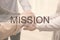 People holding hands together on background, closeup. Mission concept