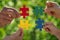 People holding multicolor jigsaw puzzle in hands