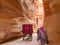 People in a horse carriage in a gorge, Siq canyon in Petra, Jordan. Petra is one of the New Seven Wonders of the World