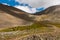 People and horses rest before crossing the pass.