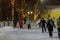 People ice skating on a large ice rink in public park in evening. Novosibirsk, Russia - 01.01.2024