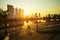 People jogging and biking bicycle in bangkok city public park against beautiful moring sunrsing sky