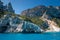 People jumping into the water at Cala Goloritze beach, Italy