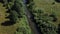 People kayaking on a forest river in the middle of the wild. Aerial top view.