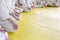 People in kimono sitting on tatami on martial arts