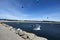 People kitesurfing  on the wavy sea under the blue sky