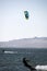 people kitsurfing in a paracas bay of peru with blue water and drops in the air and mountains in the background-june 2020