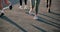 People, legs and running on road in exercise, outdoor fitness or cardio training on asphalt. Closeup of active or