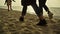 People legs stepping beach at sunset sea nature. Family walking sandy coast.