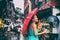 People lifestyle umbrella travel Asian woman shopping in chinatown market street. Rainy day girl tourist under red