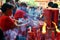 People lighting on some red candles in chinese Temple, Indonesia