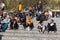 People listen to the music of street musicians sitting on the steps on Paseo Joan De Borbo