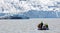 People in little inflatable rubber boat close to Vatnajokull glacier in Fjallsarlon glacier