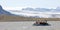 People in little inflatable rubber boat close to Vatnajokull glacier in Fjallsarlon glacier