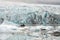 People in little inflatable rubber boat close to Vatnajokull glacier in Fjallsarlon glacier lagoon in Iceland.