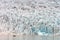 People in little inflatable rubber boat close to Vatnajokull glacier in Fjallsarlon glacier lagoon in Iceland.