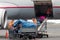 People loading luggage on the plane to the airport macedonia a r