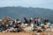 People looking through rubbish on landfill site