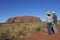 People looking at  Uluru Ayers Rock in Uluru-Kata Tjuta National Park Landscape view of Uluru-Kata Tjuta National Park Northern